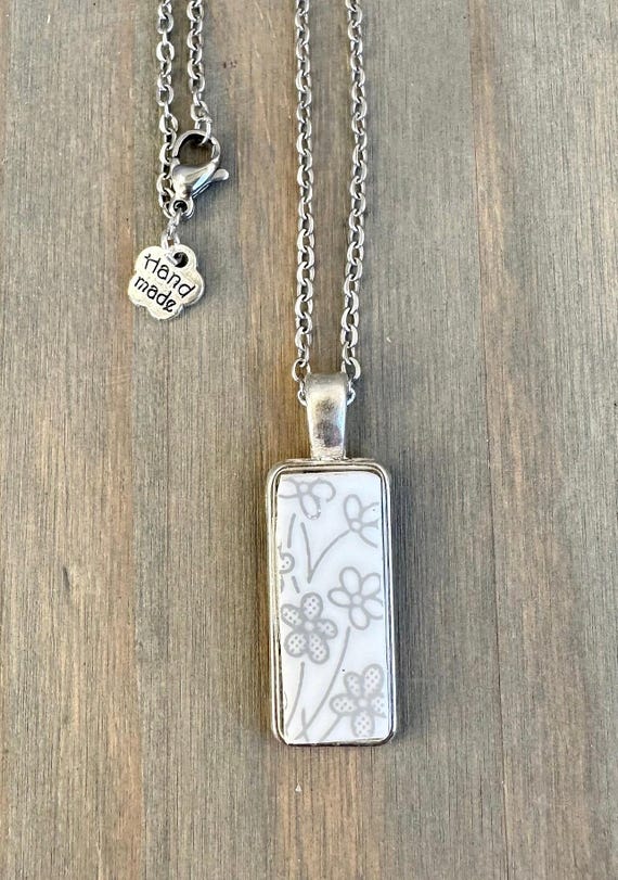 Handmade and repurposed using a vintage  Correlle “Ribbon Bouquet” plate silver pendant necklace