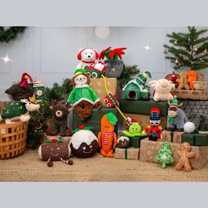 May include: A collection of Christmas-themed plush toys, including a reindeer, elf, and carrot. Other toys include a turtle, bear, and gingerbread man. The toys are arranged on wrapped gift boxes and a woven basket, with a small Christmas tree in the background.