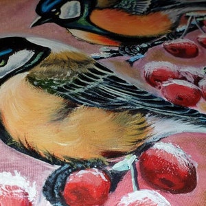 May include: A painting of two bluebirds perched on a branch with red berries. The birds are painted in a realistic style with detailed feathers and bright colors. The background is a soft pink.
