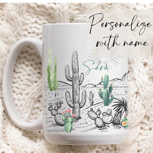 May include: White ceramic mug with a black and green cactus design. The mug has a handle and says "Sara" on the front.  Personalize with name.