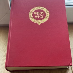 May include: A red hardback book with a gold circle on the front that says "Published annually since 1849 - Who's Who"