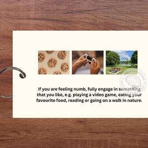 May include: A white card with a blue and white brain graphic and the text "Association Info" on the bottom right corner. The card has three images: a plate of cookies, a hand holding a video game controller, and a picnic table in a park.