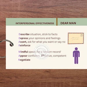 May include: A white card with a green border and the text "Interpersonal Effectiveness" and "Dear Man" in black. The card has a list of steps to help you communicate effectively, including "Describe, Express, Assert, Reinforce, Mindful, Appear, Negotiate". The card also has a small illustration of a person and a sealed envelope.