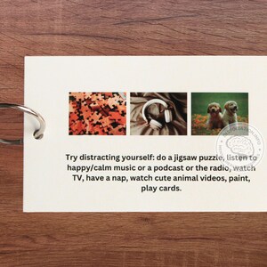 May include: A white card with a text message about distracting yourself with activities like doing a jigsaw puzzle, listening to music, watching TV, or playing cards. The card has three images: a jigsaw puzzle, headphones, and two puppies.
