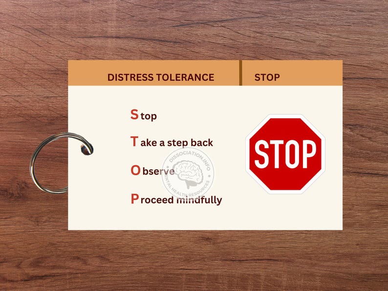 May include: A white card with the words "Distress Tolerance" and "STOP" in brown text at the top. The card has a list of four steps to help manage distress: "Stop", "Take a step back", "Observe", and "Proceed mindfully". A red stop sign with the word "STOP" in white text is on the right side of the card.