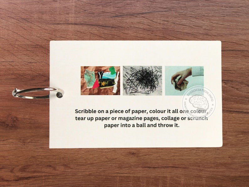 May include: A white card with instructions for a paper art activity. The card has three images: a collage of paper scraps, a pile of black paper clips, and a hand crumpling a piece of paper. The text reads: "Scribble on a piece of paper, colour it all one colour, tear up paper or magazine pages, collage or scrunch paper into a ball and throw it."