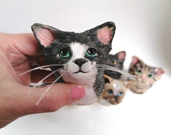 Mini cat head sculptures