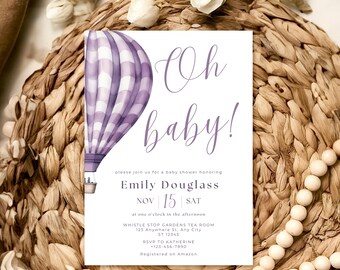Może przedstawiać: Ilustracja fioletowo-białej balonu na gorące powietrze na białej kartce z tekstem "Oh baby!" i zaproszeniem na baby shower dla Emily Douglass 15 listopada. Zaproszenie zawiera godzinę, miejsce, informacje RSVP i informację, że wydarzenie jest zarejestrowane na Amazon.