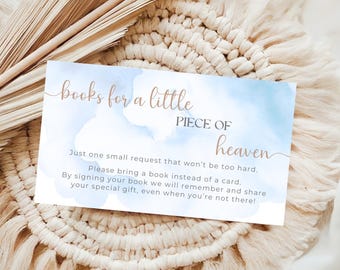 May include: A rectangular card with the text "books for a little PIECE OF heaven" in gold script. The card has a blue watercolor background and additional text requesting a book instead of a card.