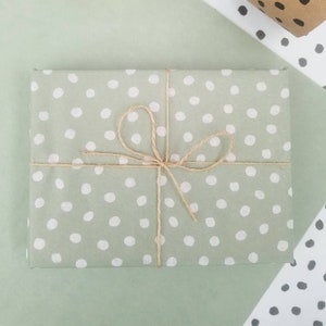 Sage green polka dot tissue paper, eco friendly soy based inks, white spotty pattern on green, recycled & recyclable. Made in the UK