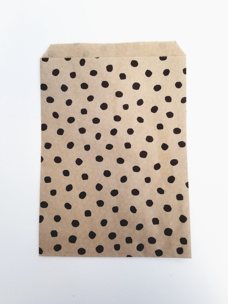 May include: A brown paper bag with a black polka dot pattern.
