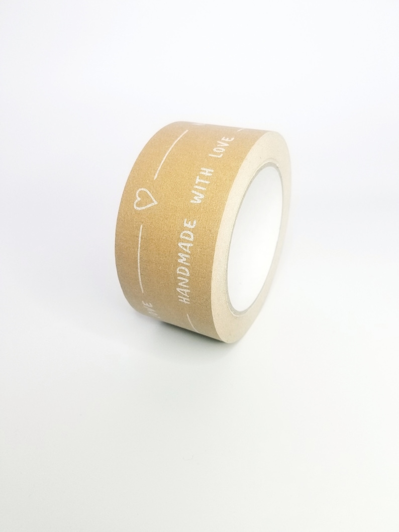 May include: A roll of brown paper tape with the text "HANDMADE WITH LOVE" and a heart printed in white.