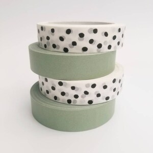 May include: Four rolls of washi tape, two are green and two are white with black and gray polka dots.
