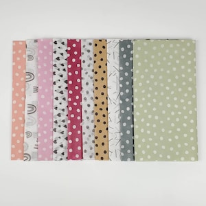 May include: Assortment of ten different patterned tissue paper sheets. The patterns include rainbows, hearts, polka dots, and lines. The colours are pink, red, orange, grey, brown, and green.