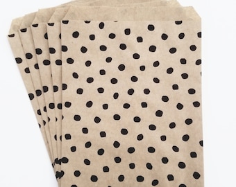 May include: A stack of brown paper bags with a black polka dot pattern.