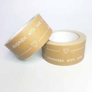May include: Two rolls of brown paper tape with white text that reads "Handmade with Love" and a small heart symbol.