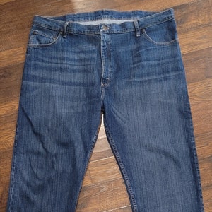 May include: A pair of dark blue denim jeans with a classic straight leg fit.