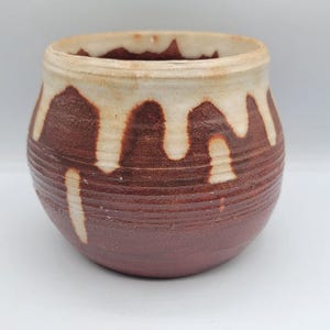 May include: A set of three ceramic mugs with a speckled, matte finish. Each mug is a different colour: light blue, cream, and grey. The mugs have a simple, modern design and a comfortable handle.