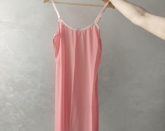May include: A pale pink sleeveless slip dress with thin straps.