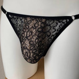 May include: Black lace underwear with a delicate floral pattern.