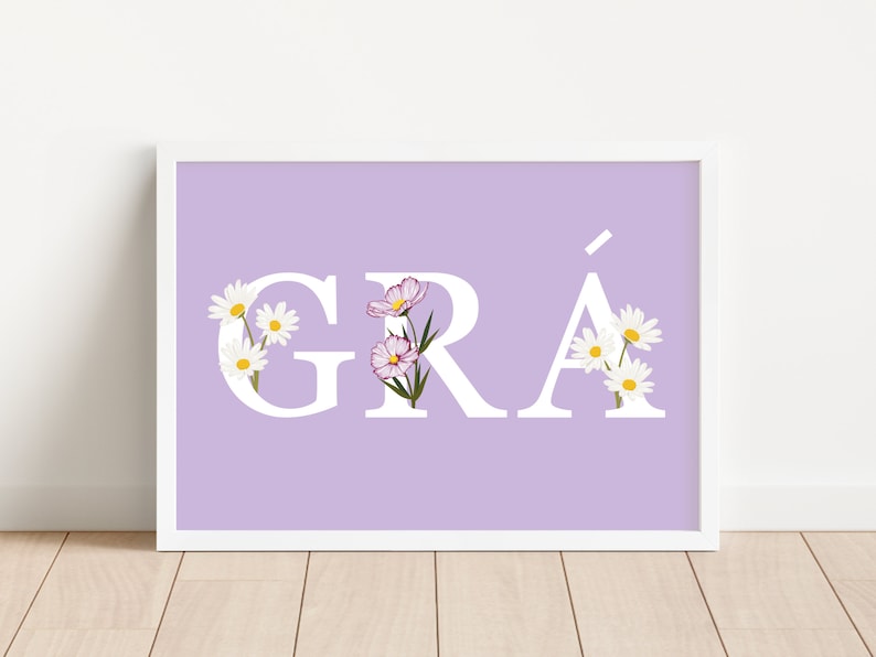 May include: A light purple printable wall art print with the word "GR&Aacute;" in white letters with white flowers and pink flowers in the letters.