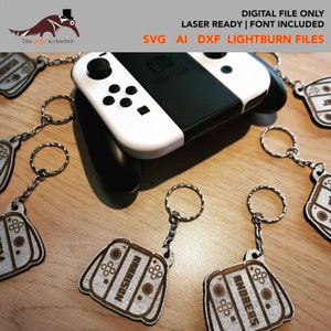 May include: A set of laser-cut wooden keychains shaped like a Nintendo Switch console. The keychains are brown with white details and feature the text "HARRISON" and "ANDRERS".