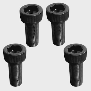 May include: Four black socket head cap screws. Each screw has a cylindrical head with a hexagonal socket and a threaded shaft. The screws are arranged against a light gray background.
