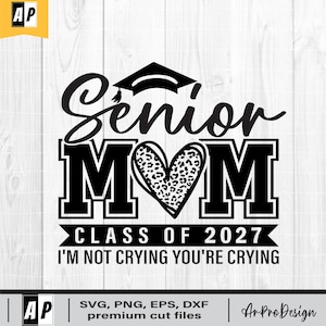 May include: A black graphic design featuring the text Senior MOM with a graduation cap above the word Senior and a leopard print heart replacing the letter O. Below is the text CLASS OF 2027 and I'M NOT CRYING YOU'RE CRYING in black.