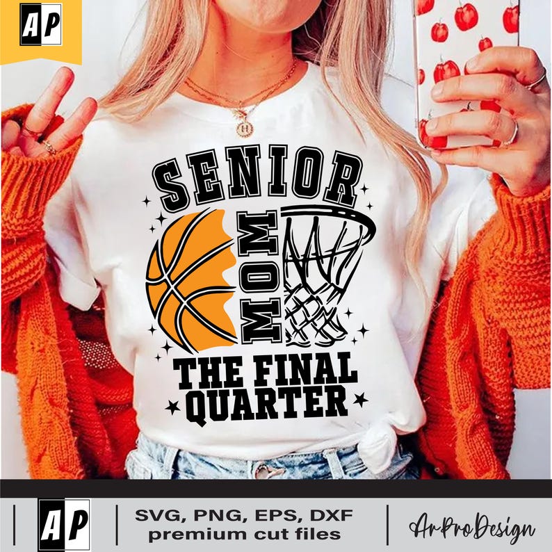 May include: White t-shirt with a black basketball and hoop graphic. The text "Senior Mom The Final Quarter" is printed on the shirt.