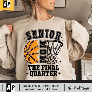 May include: A beige sweatshirt with a basketball and a basketball hoop graphic. The text "Senior Mom The Final Quarter" is printed on the sweatshirt.