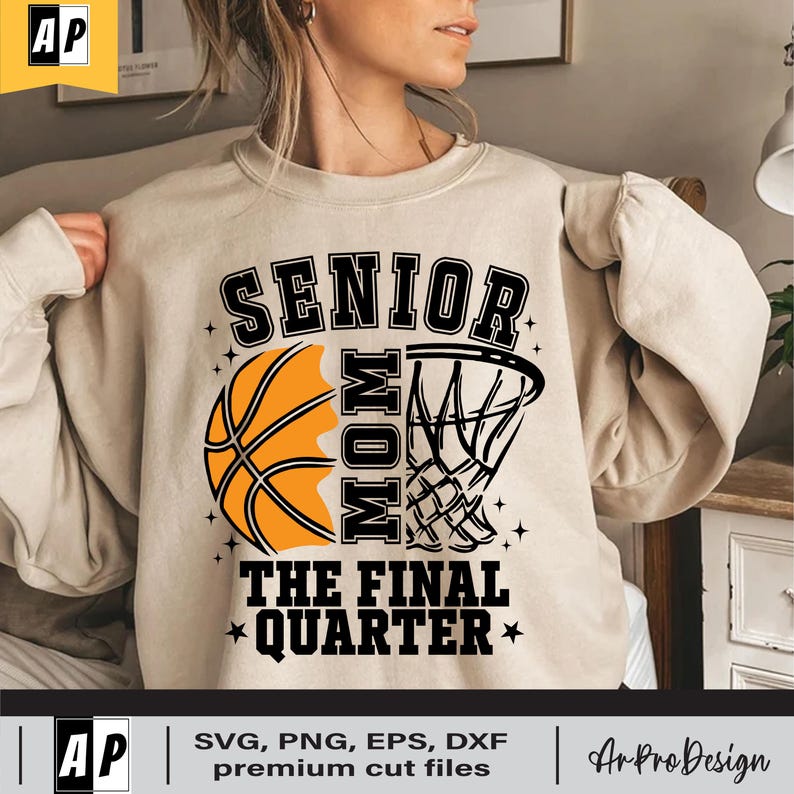 May include: A beige sweatshirt with a basketball and a basketball hoop graphic. The text "Senior Mom The Final Quarter" is printed on the sweatshirt.