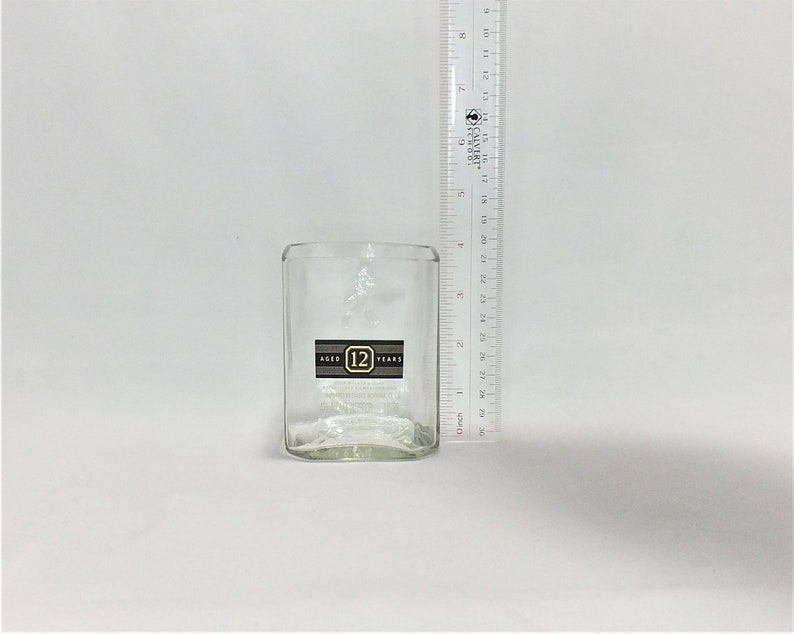 May include: A clear glass tumbler with a label that reads "Aged 12 Years".
