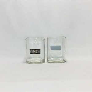 May include: Two clear glass tumblers, one with a label that reads "Aged 12 Years".