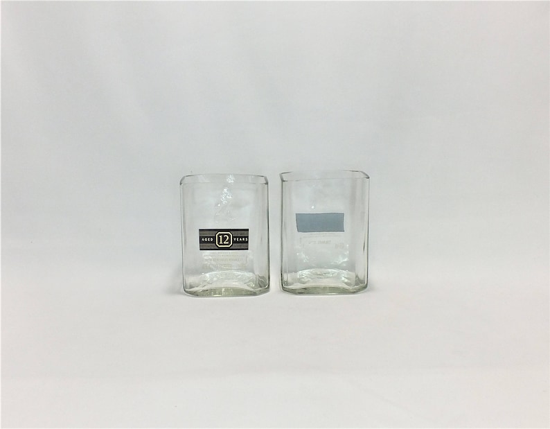 May include: Two clear glass tumblers, one with a label that reads "Aged 12 Years".