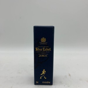 May include: A blue box with gold lettering for Johnnie Walker Blue Label Blended Scotch Whisky. The box features the Johnnie Walker logo and the text "50ml 40% Alc/Vol (80 Proof)".