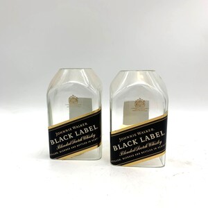 May include: Two empty glass bottles with the Johnnie Walker Black Label logo and text "Blended Scotch Whisky" on the labels.