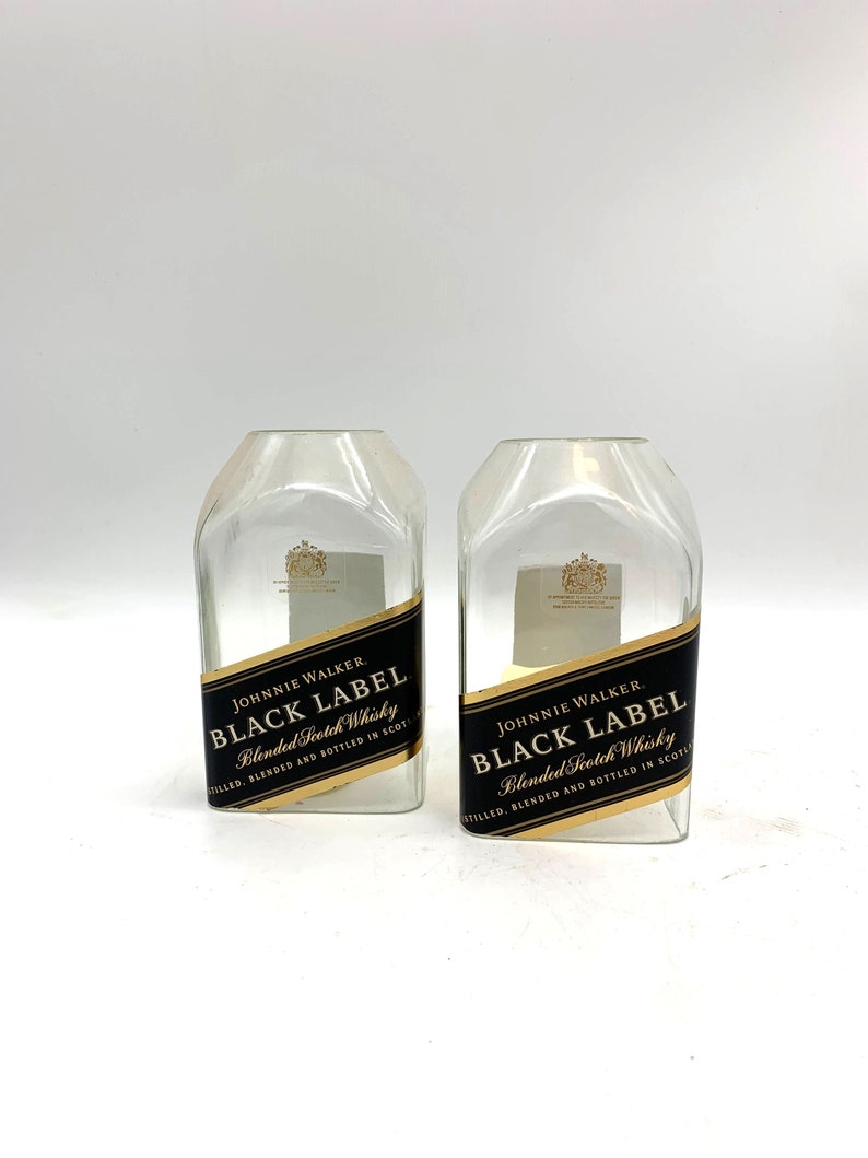 May include: Two empty glass bottles with the Johnnie Walker Black Label logo and text "Blended Scotch Whisky" on the labels.