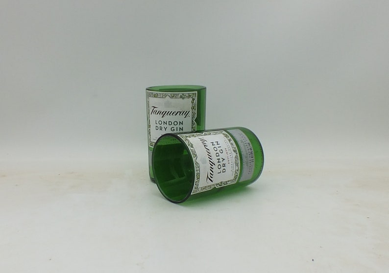May include: Two empty green glass bottles with the label "Tanqueray London Dry Gin" on them.