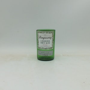May include: A green glass bottle with a white label that reads "Tanqueray London Dry Gin" and "ESTD 1830".