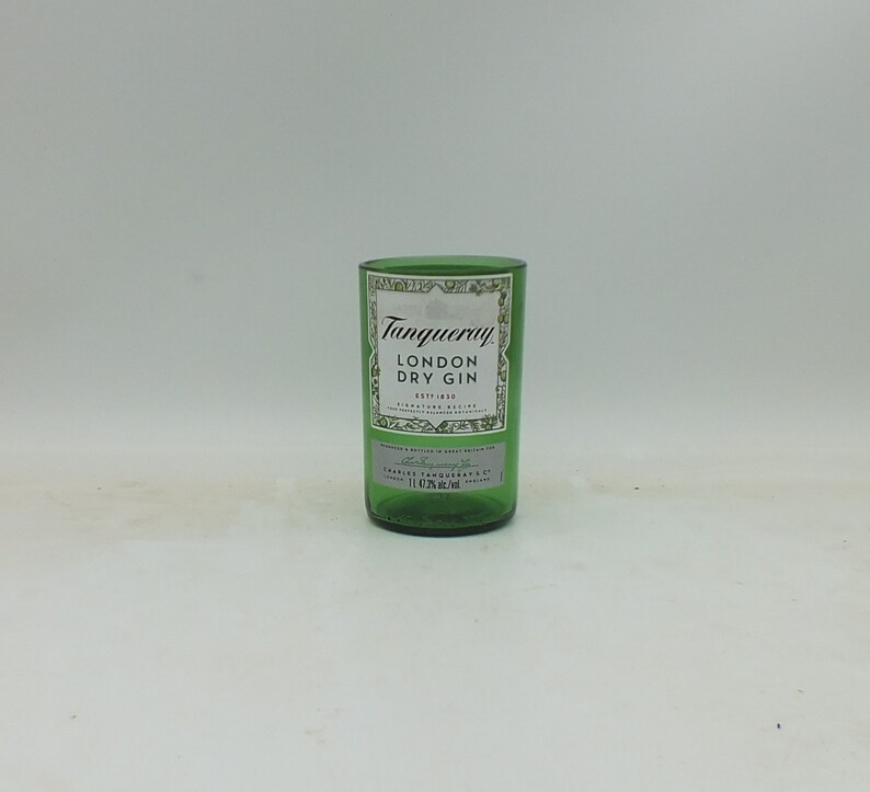 May include: A green glass bottle with a white label that reads "Tanqueray London Dry Gin" and "ESTD 1830".