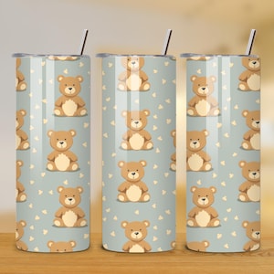 May include: Three stainless steel tumblers with a light blue background and a repeating pattern of brown teddy bears.