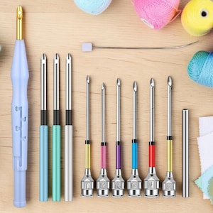 May include: A light blue punch needle tool with a gold tip, alongside a set of interchangeable needles with colored accents. Colorful yarn balls in pink, yellow, purple, and blue are scattered around the tools, suggesting a crafting theme.