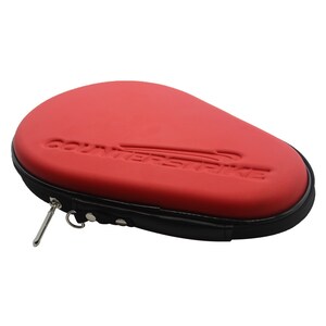 May include: Red and black ping pong paddle case with a zipper closure and the word "COUNTERSTRIKE" embossed on the front.