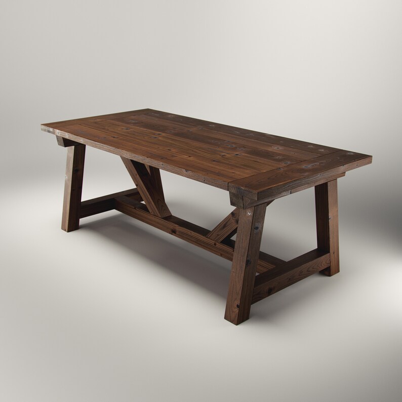 May include: A dark brown wooden dining table with a rectangular top and a rustic design. The table has a planked surface and angled legs connected by crossbeams. The table is approximately 183 cm long.
