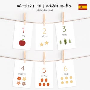 May include: A set of number flashcards, 1-6, hanging from a string with wooden clothespins. Each card displays a number in Spanish, a corresponding illustration, and the number in numeral form. The cards are white with a neutral color palette.