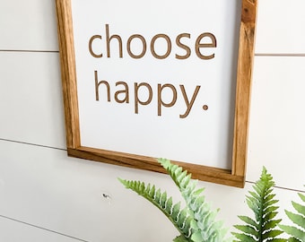 May include: A framed wooden sign with the text "choose happy" in white lettering on a white background.