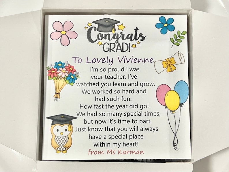 May include: A graduation card with a colorful illustration of a graduation cap, flowers, and balloons. The card reads "Congrats GRAD! To Lovely Vivienne I'm so proud I was your teacher. I've watched you learn and grow. We worked so hard and had such fun. How fast the year did go! We had so many special times, but now it's time to part. Just know that you will always have a special place within my heart! from Ms Karman"