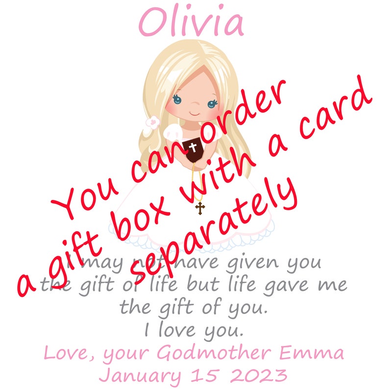 May include: A white card with a pink and white illustration of a girl in a white dress holding a book. The text "Olivia" is at the top of the card. The text "You can order a gift box with a card separately" is written in red and white on the card. The text "may have given you the gift of life but life gave me the gift of you. I love you." is written in black. The text "Love, your Godmother Emma January 15 2023" is written in pink at the bottom of the card.