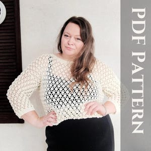 May include: Cream-colored, open-weave crochet top with three-quarter sleeves. The top is paired with a black garment. The image includes the text "PDF PATTERN" in a vertical orientation on a gray background.