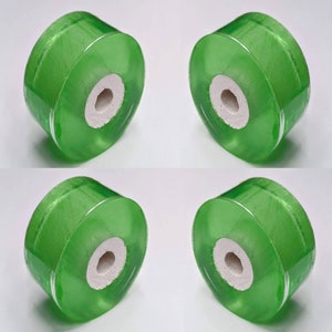 May include: Four green, translucent, cylindrical, round, smooth, plastic bottle stoppers with a white center hole.